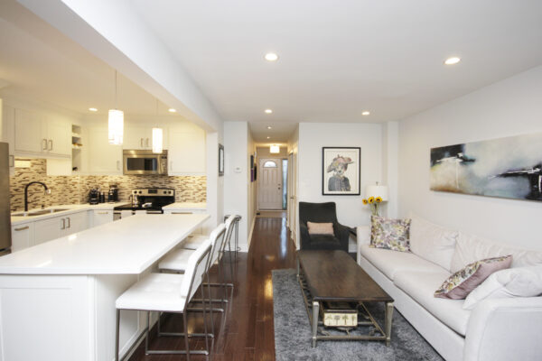 White living room and kitchen and hallway