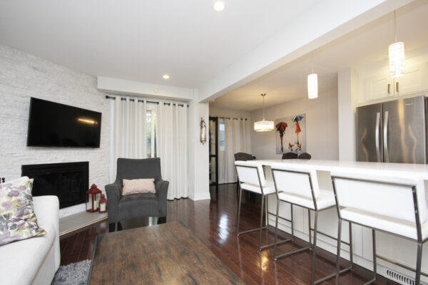 Angled view of the living room, kitchen, and dining room