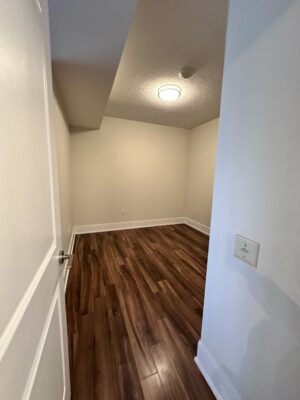 Empty bedroom with beige walls and simple light fixture