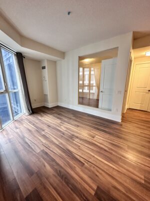 Empty living room with window panels and glass wall and doors