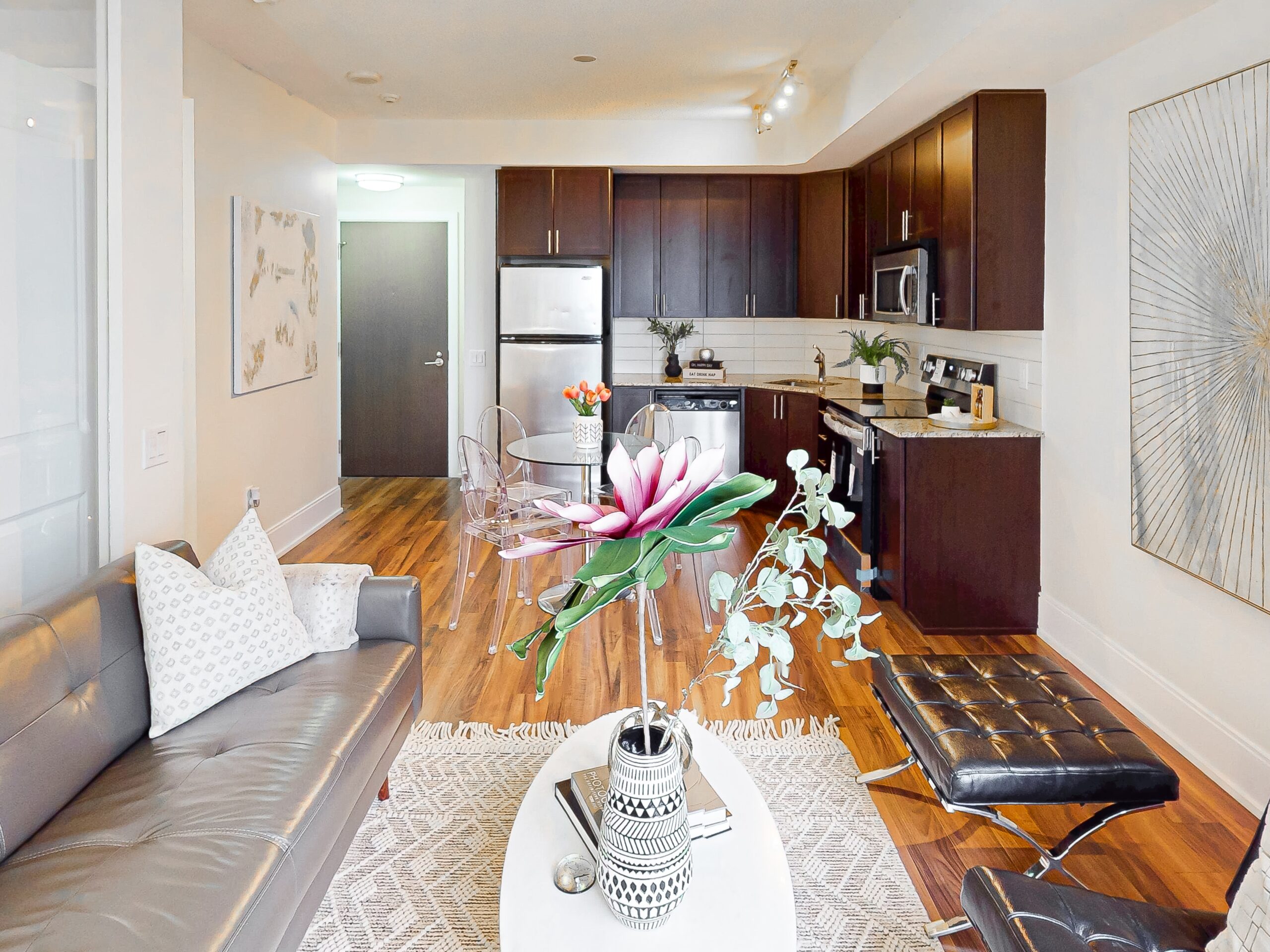Living room to kitchen view apartment with sofa, coffee table, and dining area