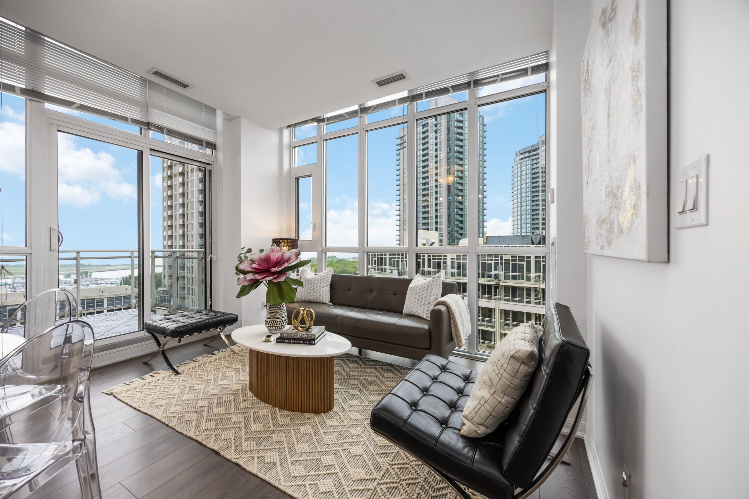 Penthouse condo living room with modern furniture and high-level sky views