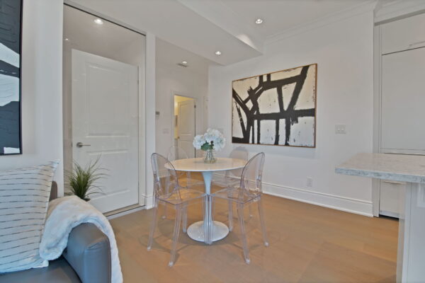 White table, clear chairs, and abstract painting on the wall