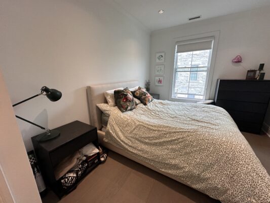 Bedroom with a night stand and lamp and bed