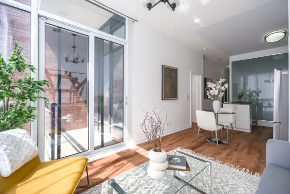 Open concept living room and dining table and sliding glass doors to balcony