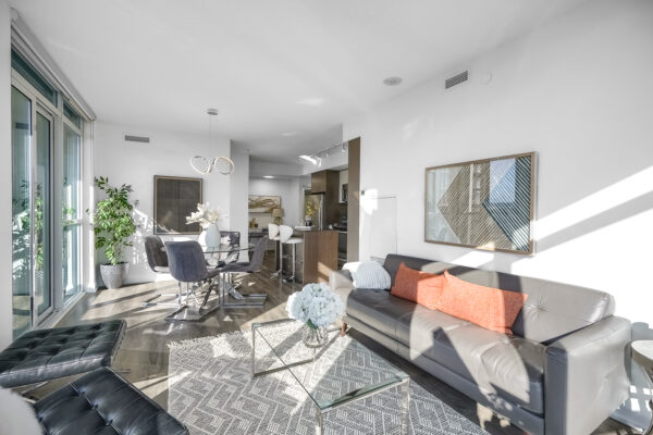 Open concept condo with a living room, dining room, kitchen, and den