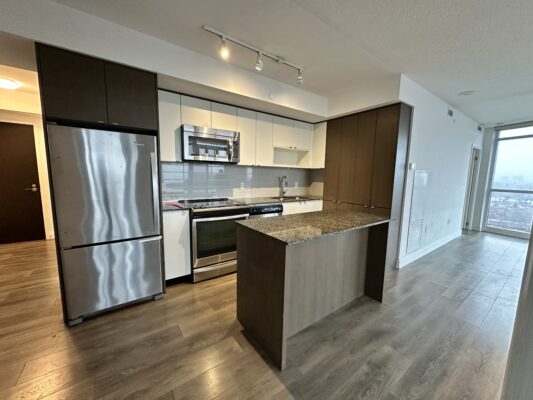 Modern kitchen with brown and beige cabinetry and stainless steel appliances