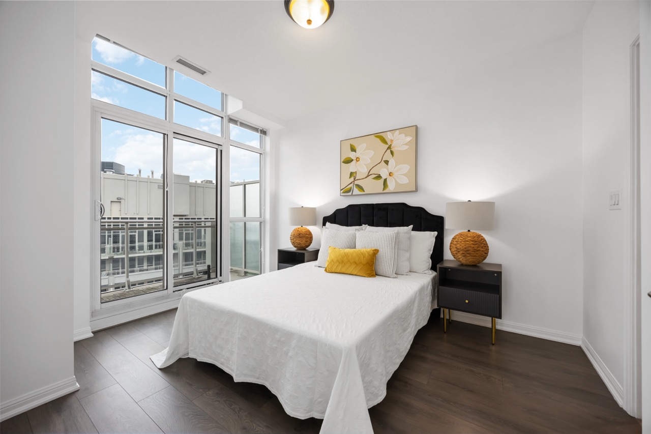 Bright bedroom staged with black and yellow accents