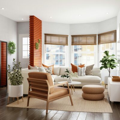Bright living room with white sectional, tan leather chair, and plants.